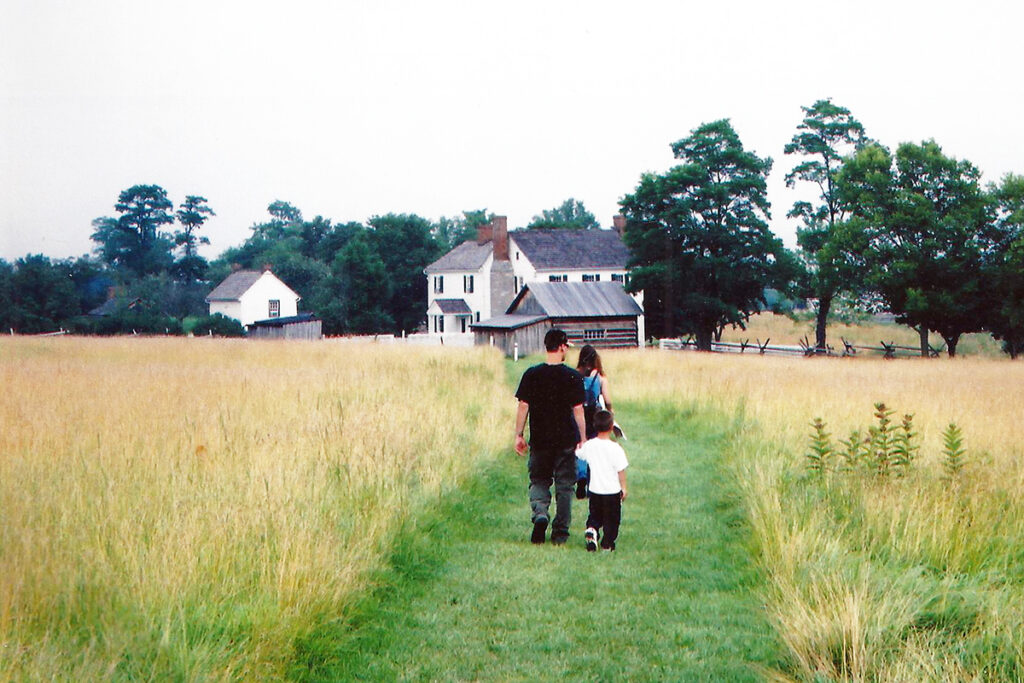 Photo of a family walking within a farm landscape