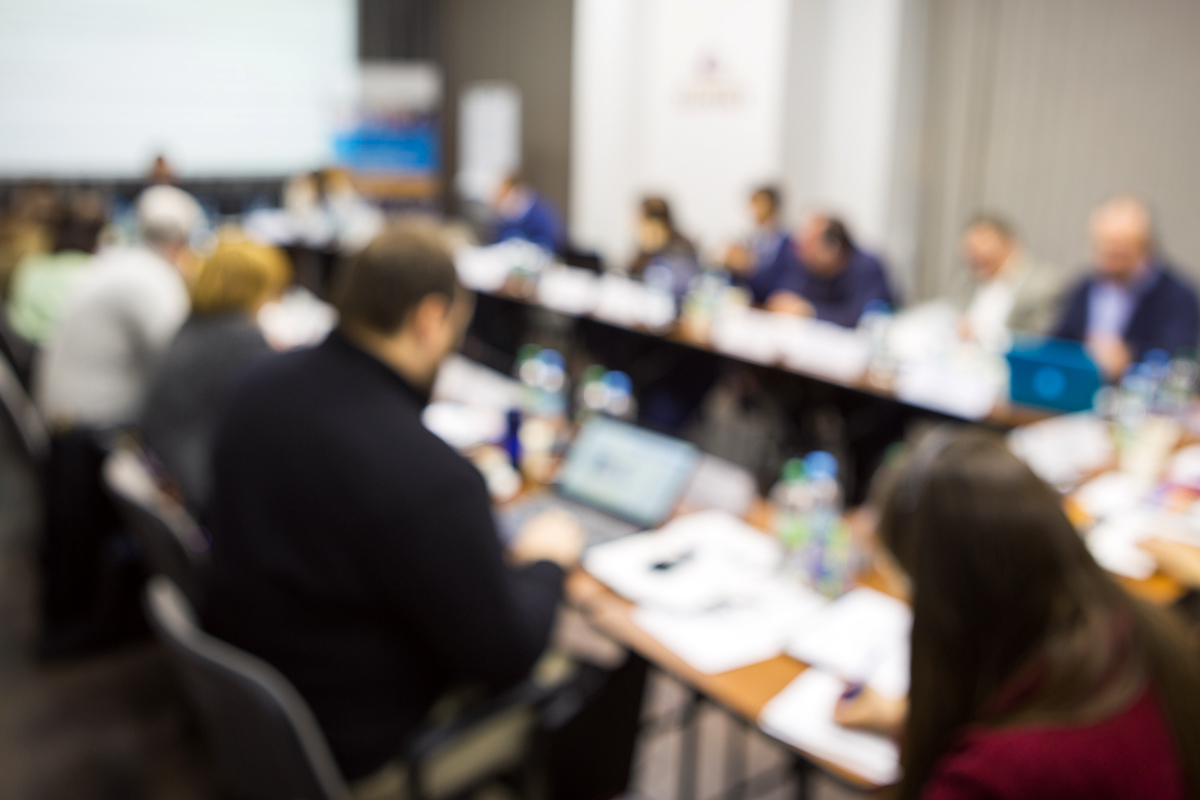 A Board of Directors seated at a meeting