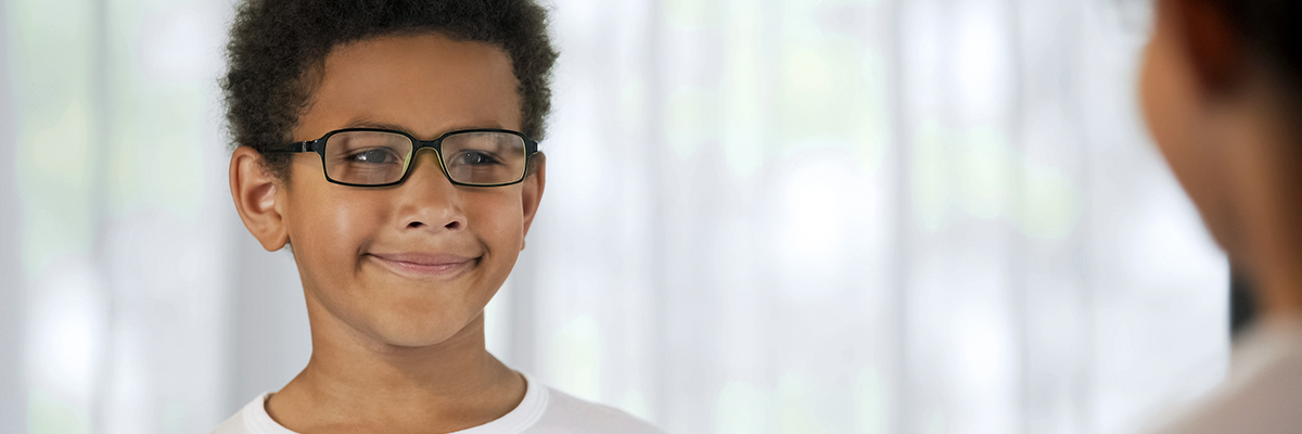 A happy young man with glasses