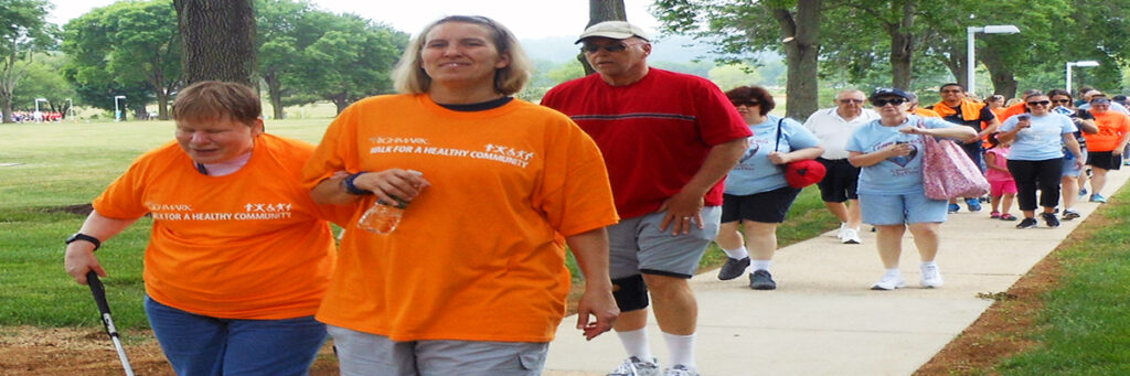 Photo of an agency client and an employee participating in the Highmark Walk for a Healthy Community