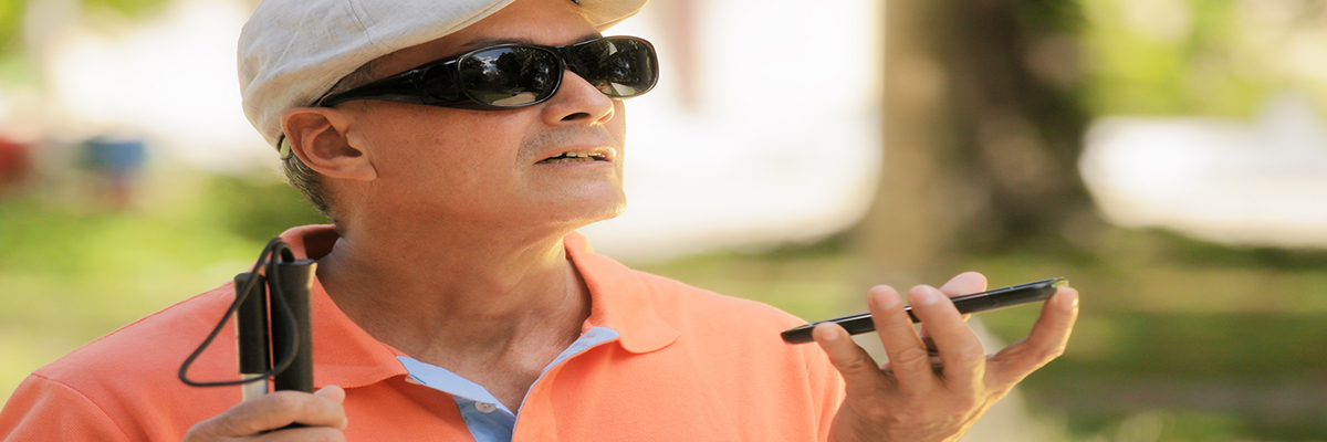 Photo of a man with a visual impairment using a smartphone