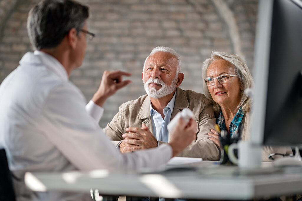 Photo of a senior couple having consultations about their supplement pills with a doctor