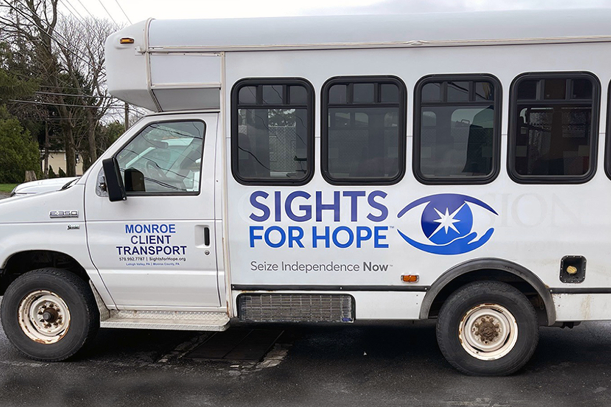 A Sights for Hope transport vehicle decorated with the agency's logo