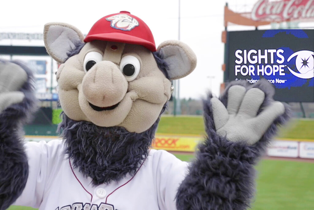 Picture of Lehigh Valley IronPigs mascot FeRROUS at Coca-Cola Park with the Sights for Hope logo on the stadium's video board