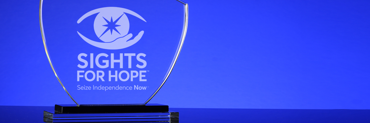 Photo of a glass trophy with the Sights for Hope logo