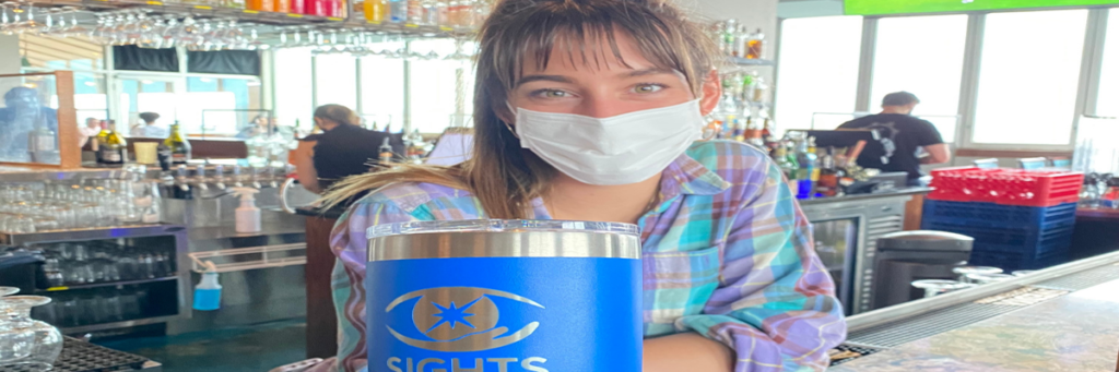 Photo of a woman holding a YETI rambler with the Sights for Hope logo