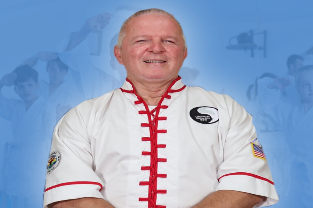 Paul Miller in a white martial arts uniform in front of a blue background