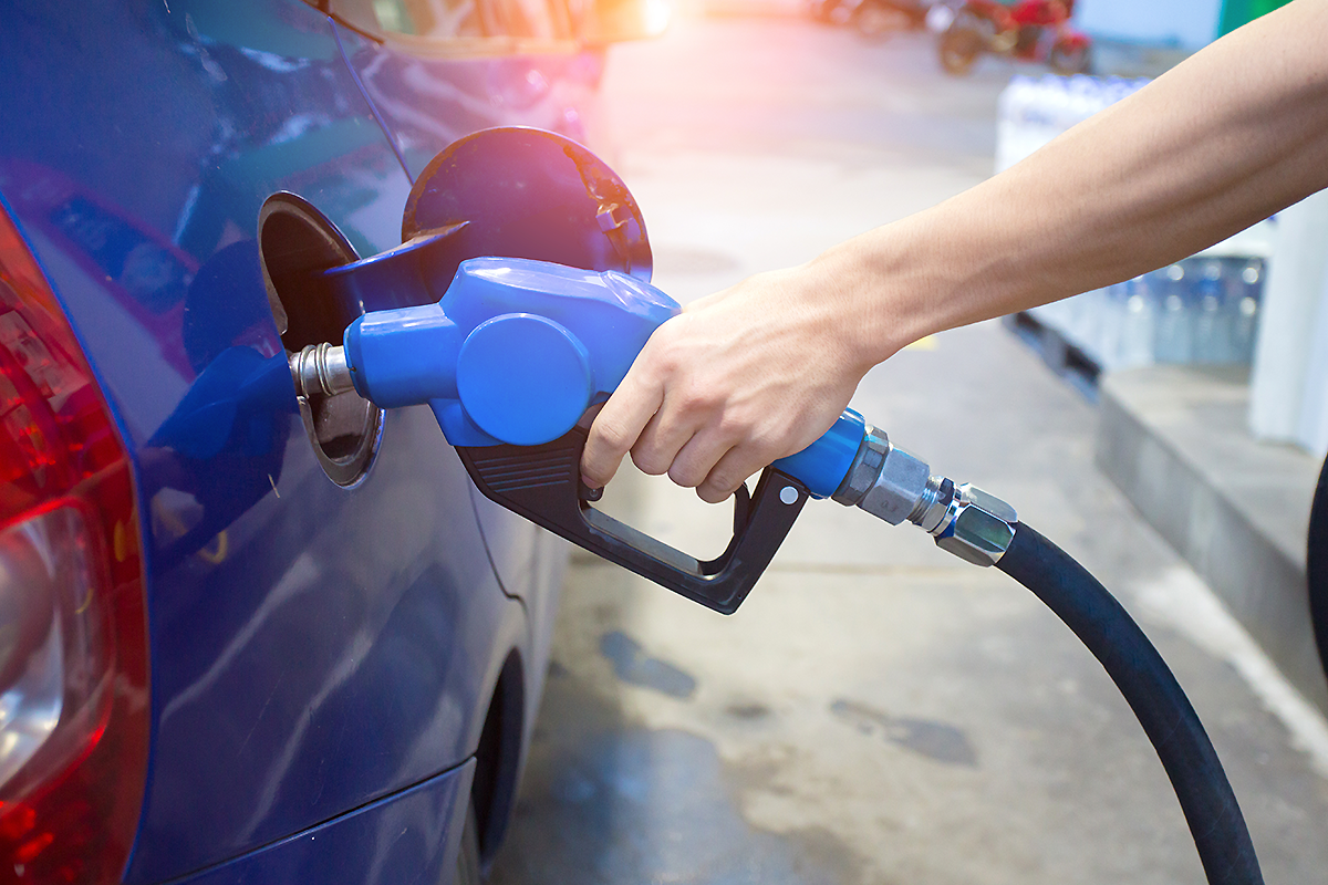 Image: Photo of a person fueling their vehicle at a gas station