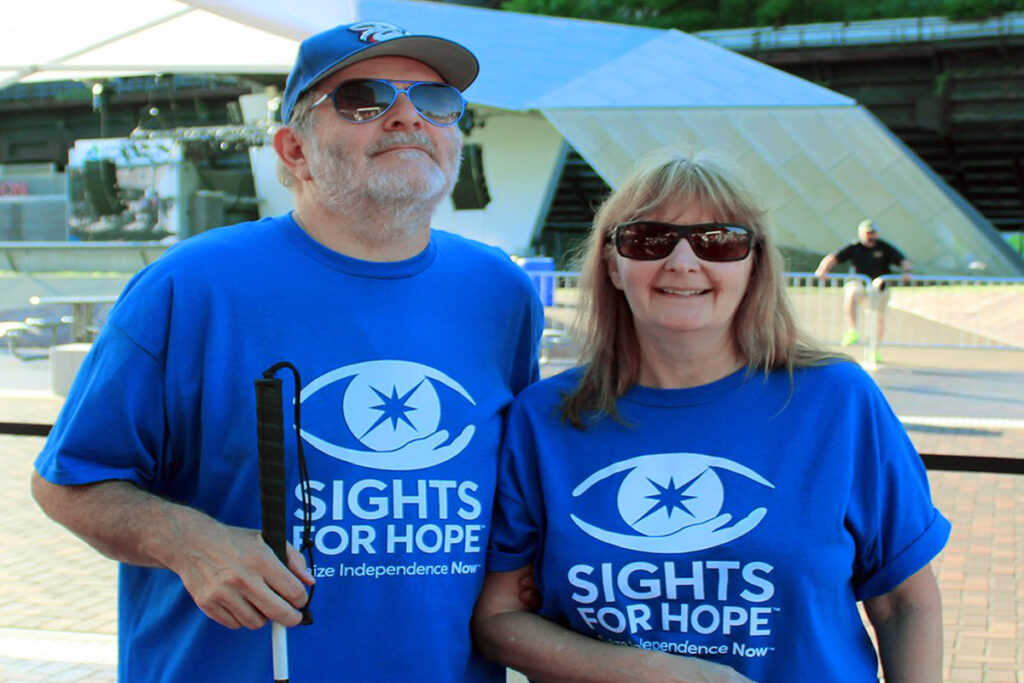 Two Sights for Hope clients who are wearing blue Sights for Hope shirts