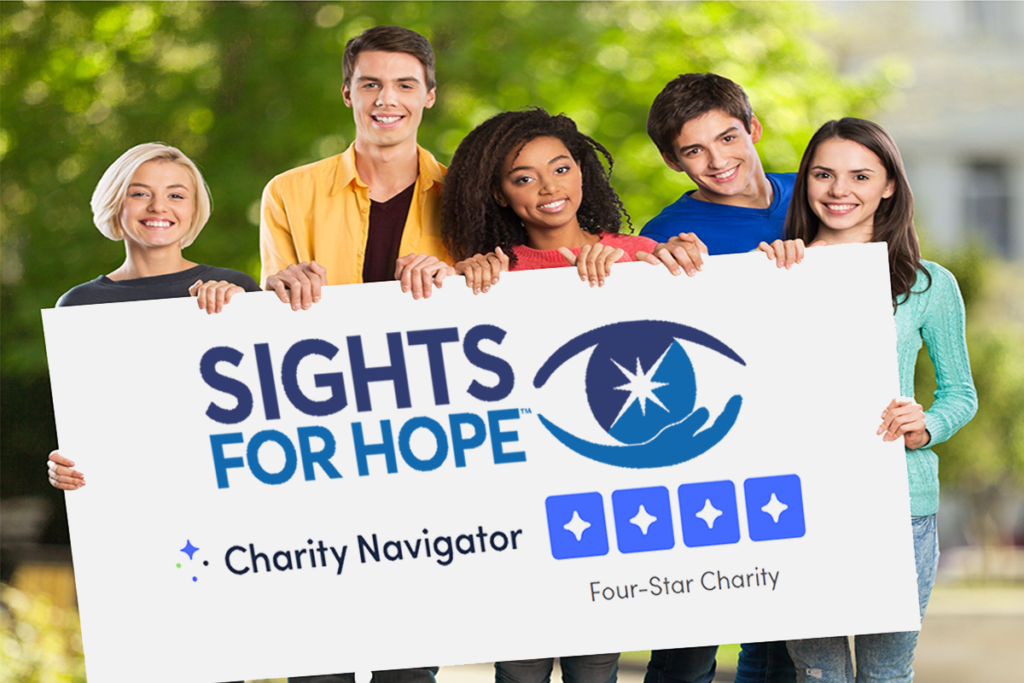 Photo of a diverse group of people holding a sign displaying Sights for Hope's four-star rating on Charity Navigator