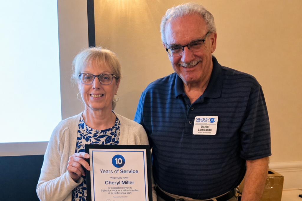 A Sights for Hope team member receiving an award during the Team Appreciation Luncheon, presented by the organization’s Board Treasurer in recognition of their service and contributions.