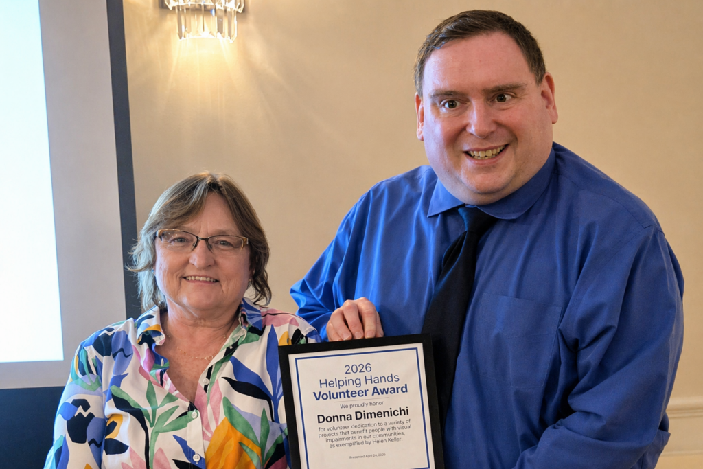 A Sights for Hope team member receiving an award during the Team Appreciation Luncheon, presented by the organization’s CEO in recognition of their service and contributions.