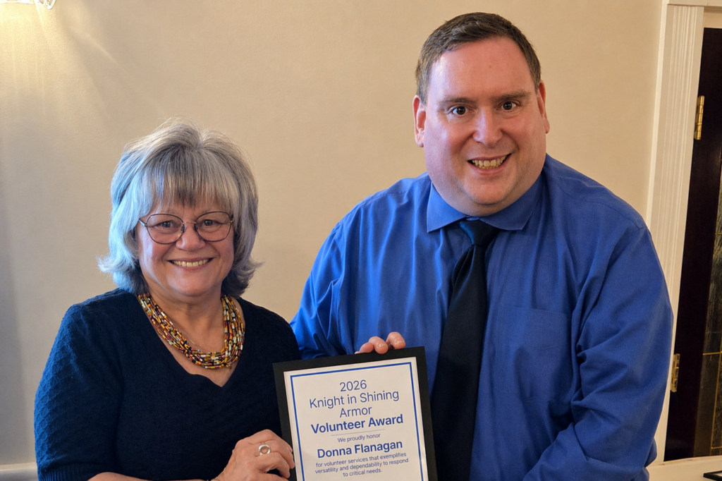 A Sights for Hope team member receiving an award during the Team Appreciation Luncheon, presented by the organization’s CEO in recognition of their service and contributions.