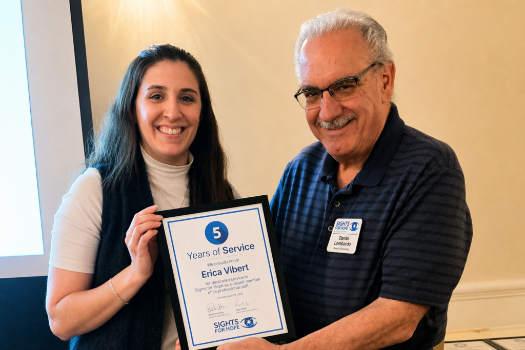A Sights for Hope team member receiving an award during the Team Appreciation Luncheon, presented by the organization’s Board Treasurer in recognition of their service and contributions.