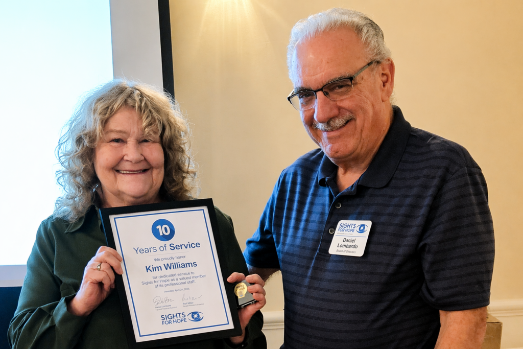 A Sights for Hope team member receiving an award during the Team Appreciation Luncheon, presented by the organization’s Board Treasurer in recognition of their service and contributions.
