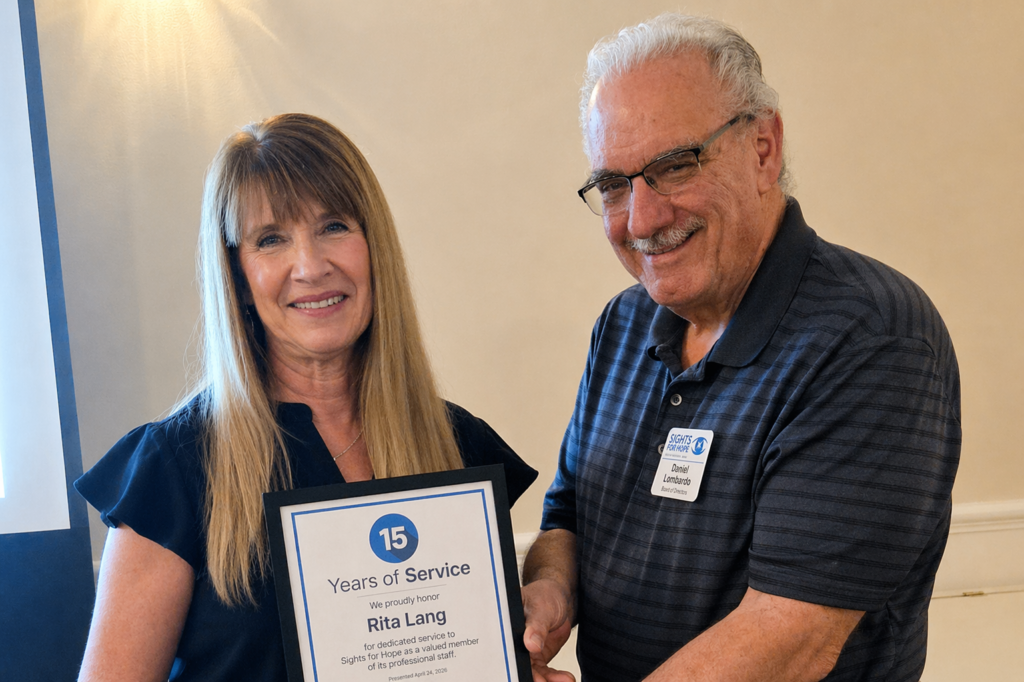 A Sights for Hope team member receiving an award during the Team Appreciation Luncheon, presented by the organization’s Board Treasurer in recognition of their service and contributions.